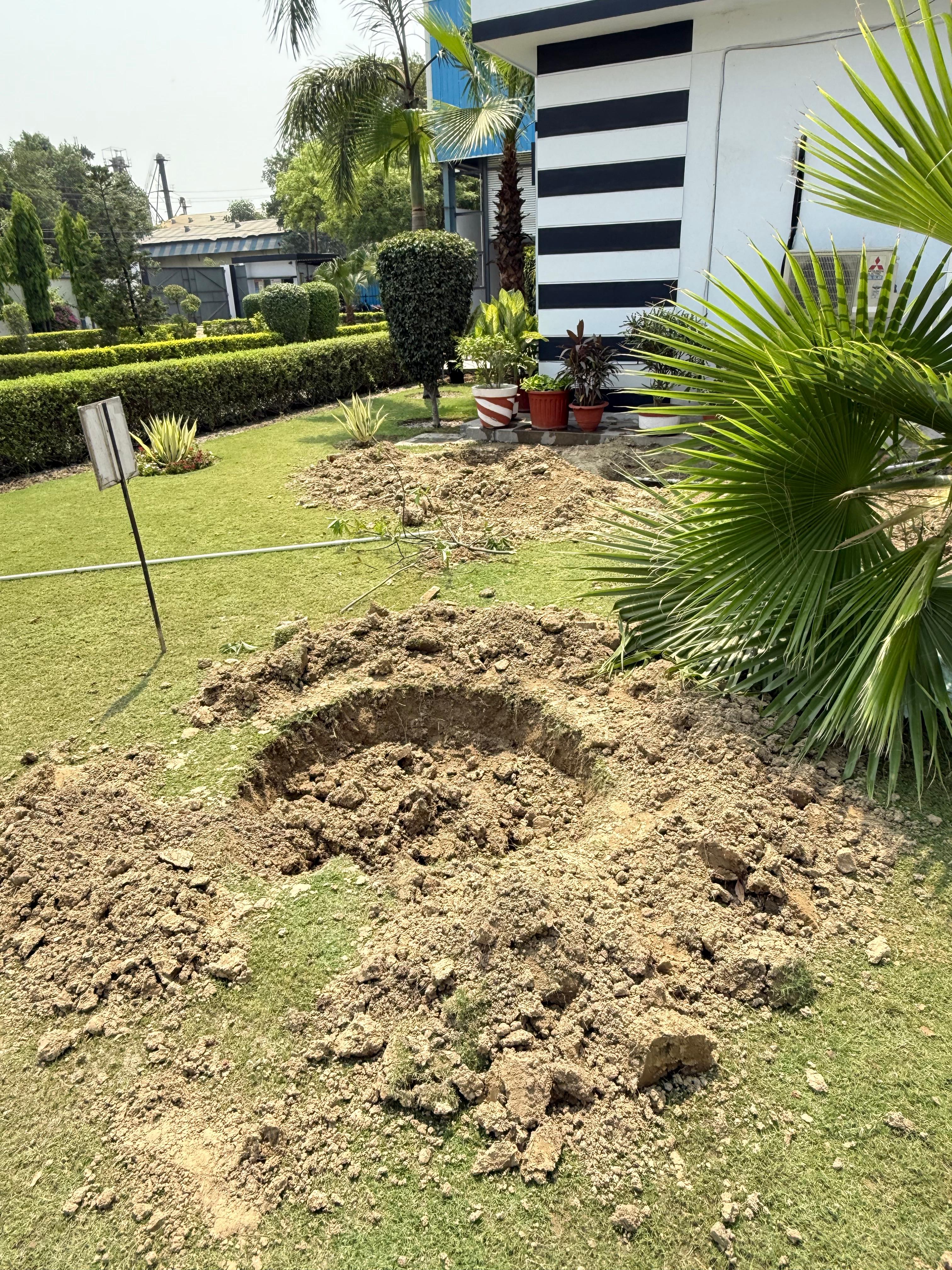 A hole prepared to relocate an existing plant during construction at Triveni's facility